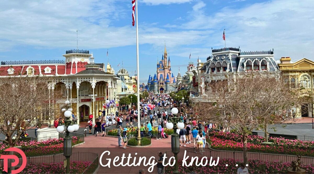 Getting to Know Disney World Main Street article cover showing a wide shot of Main Street U.S.A. from the train station with the castle in the distance.