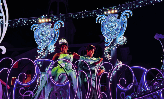 Tiana appears in a green dress on a Disney Starlight Parade float.