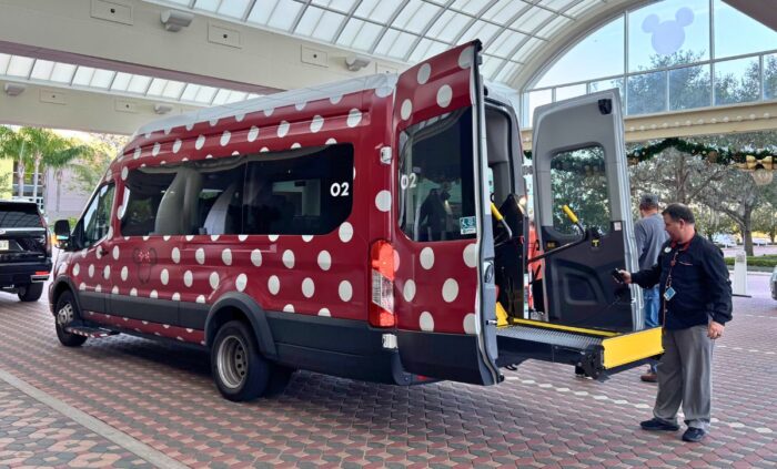 An accessible Minnie Van lowering its lift.