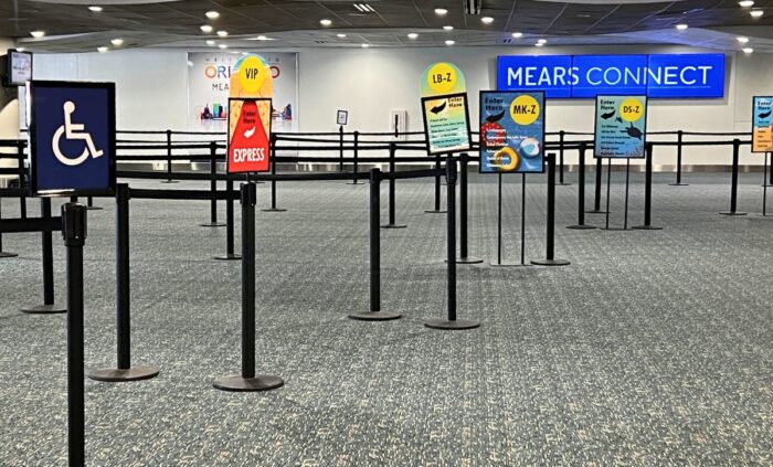 A queue area with marked lanes for Mears Connect pickup at the airport terminal