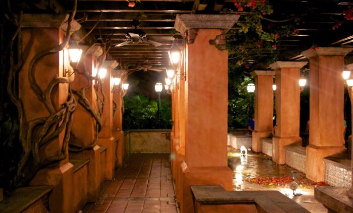 An exterior corridor and arbor with an abandoned look about it